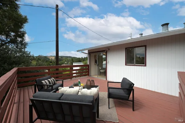 a backyard of a house with table and chairs
