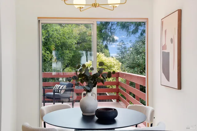 a balcony with wooden floor outdoor seating and yard in the back