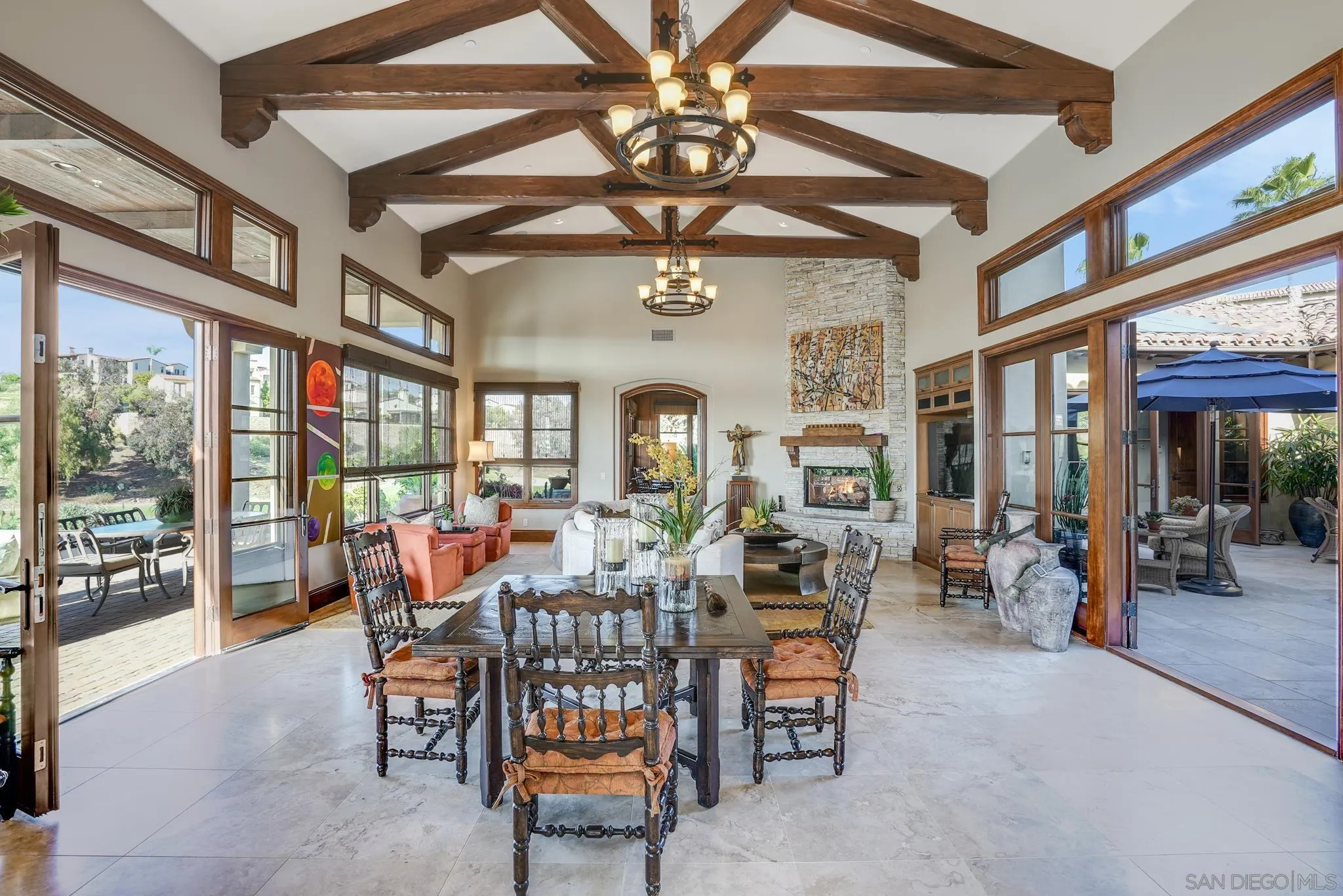 16581 Rd To Rio San Diego, CA 92127 - Photo 31 of 48 a dining room with furniture a chandelier and fireplace