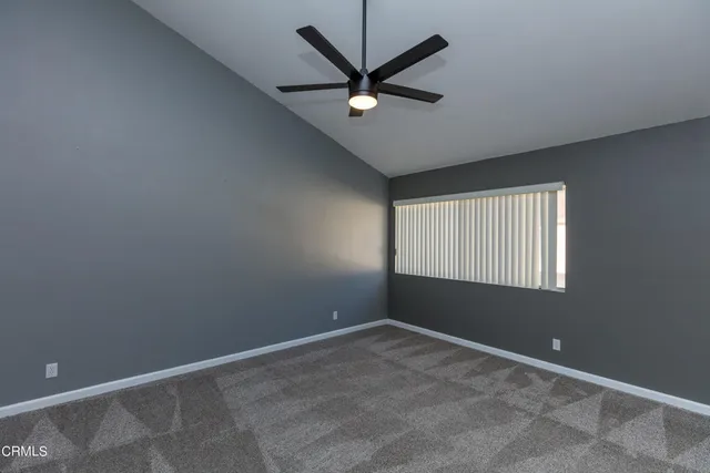 a view of room with window and ceiling fan