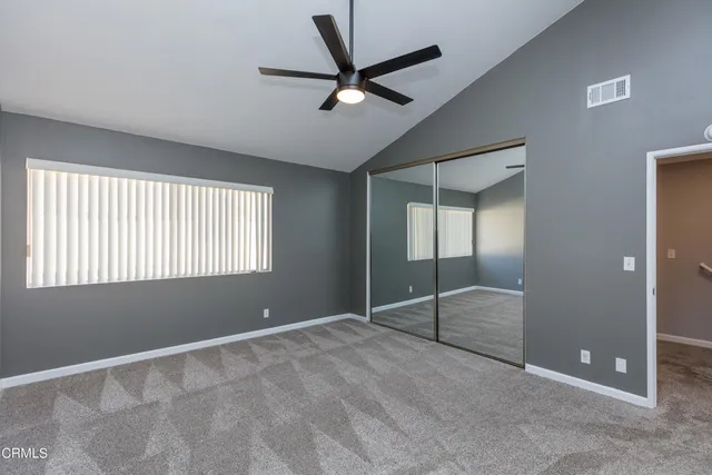 a view of an empty room with a ceiling fan
