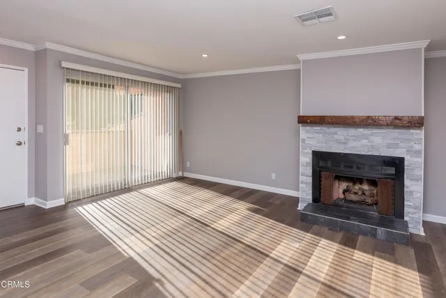 a view of a livingroom with a fireplace and window