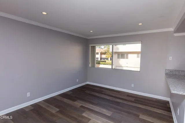 a room with wooden floor and windows