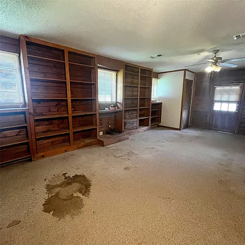 a view of empty room with furniture and window