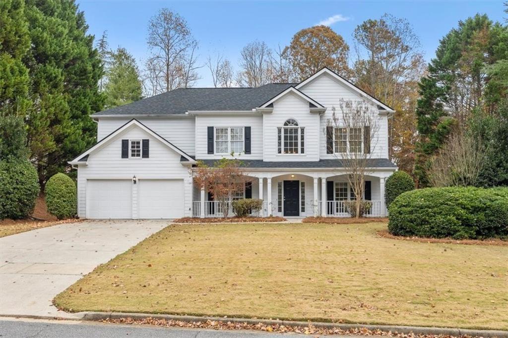 a view of house with yard and sitting area