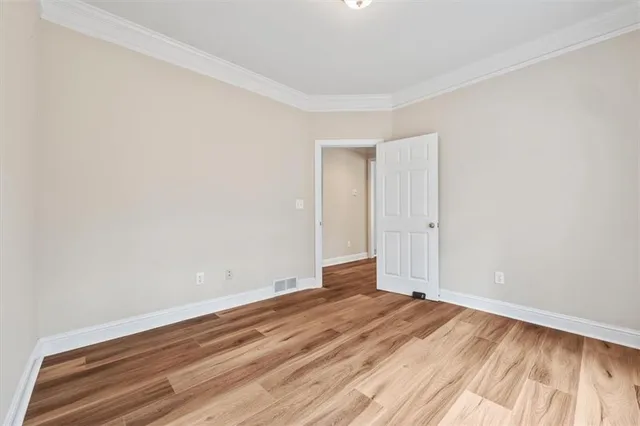 a view of room with wooden floor