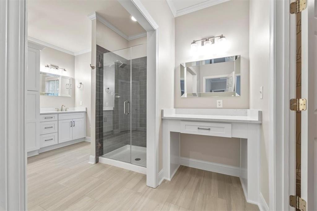 4115 Montvale Crossing Cumming, GA 30041 - Photo 20 of 40 a bathroom with a shower sink and mirror
