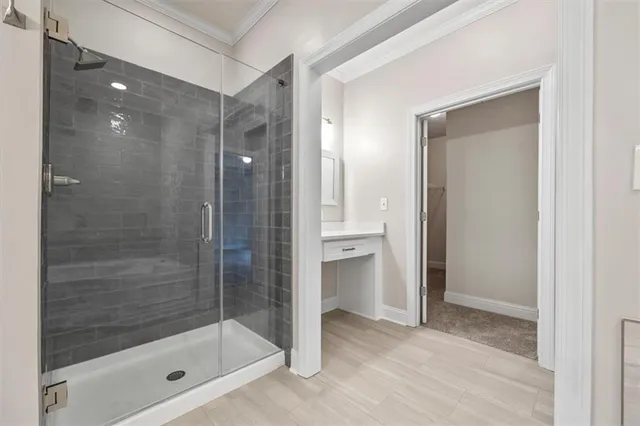 a bathroom with a shower and a glass door
