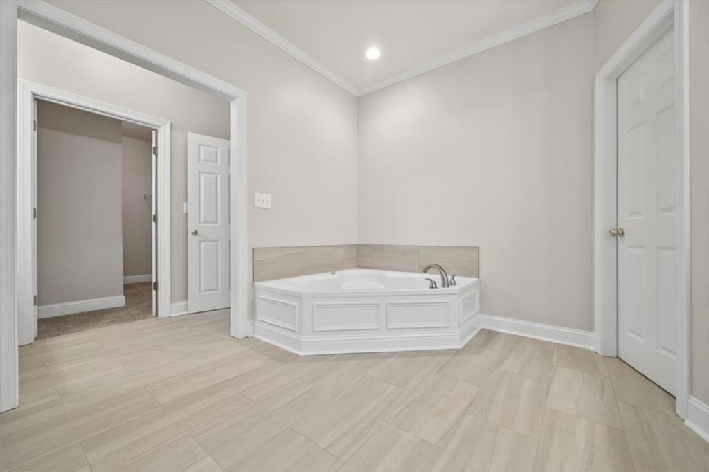 4115 Montvale Crossing Cumming, GA 30041 - Photo 23 of 40 a bathroom with a bathtub and shower