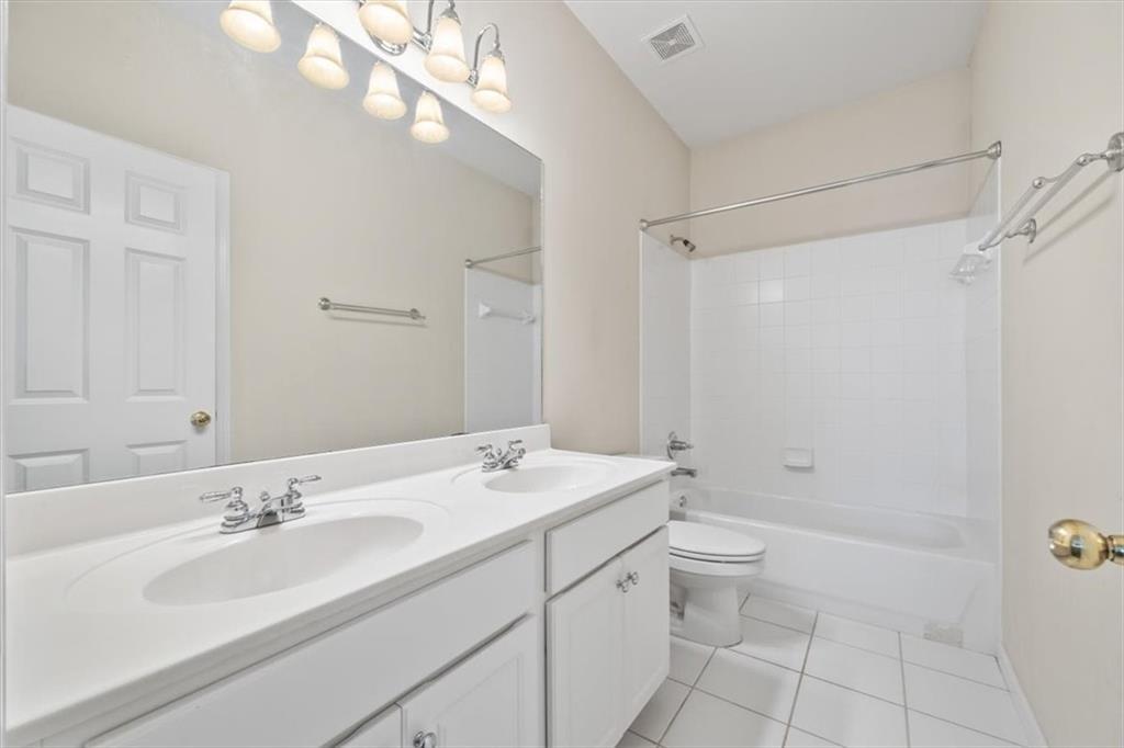 4115 Montvale Crossing Cumming, GA 30041 - Photo 28 of 40 a bathroom with a sink a toilet and shower