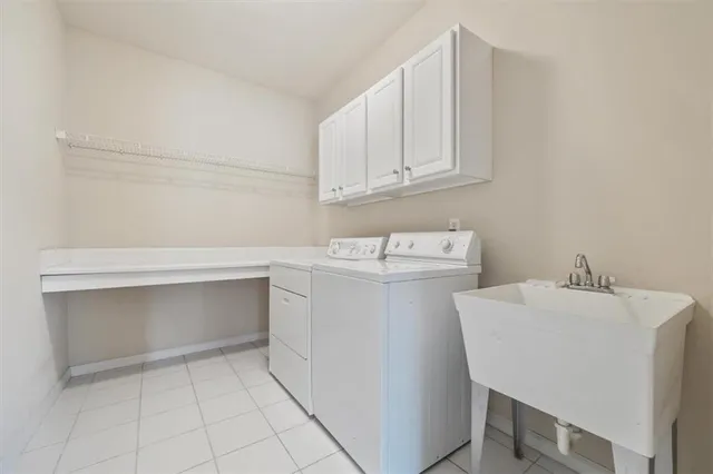 a utility room with sink dryer and washer