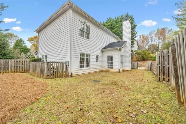 a view of a house with wooden fence