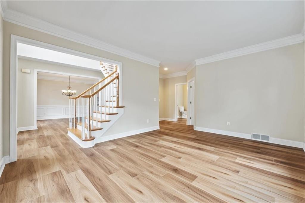 4115 Montvale Crossing Cumming, GA 30041 - Photo 4 of 40 a view of empty room with stairs and wooden floor