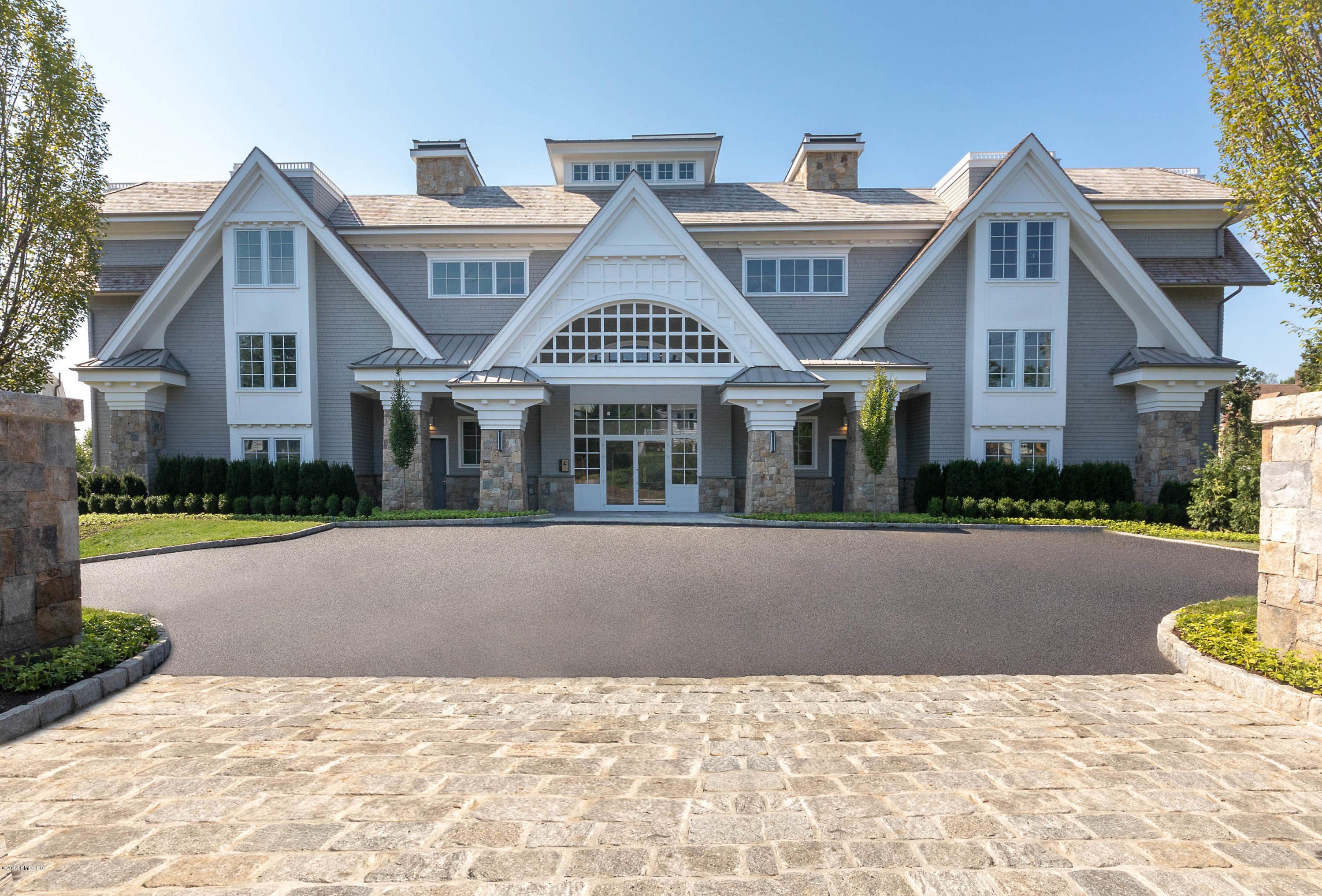 70 Sound View Drive, Unit 2 WEST Greenwich, CT 06830 - Photo 2 of 12 a front view of house with yard and green space