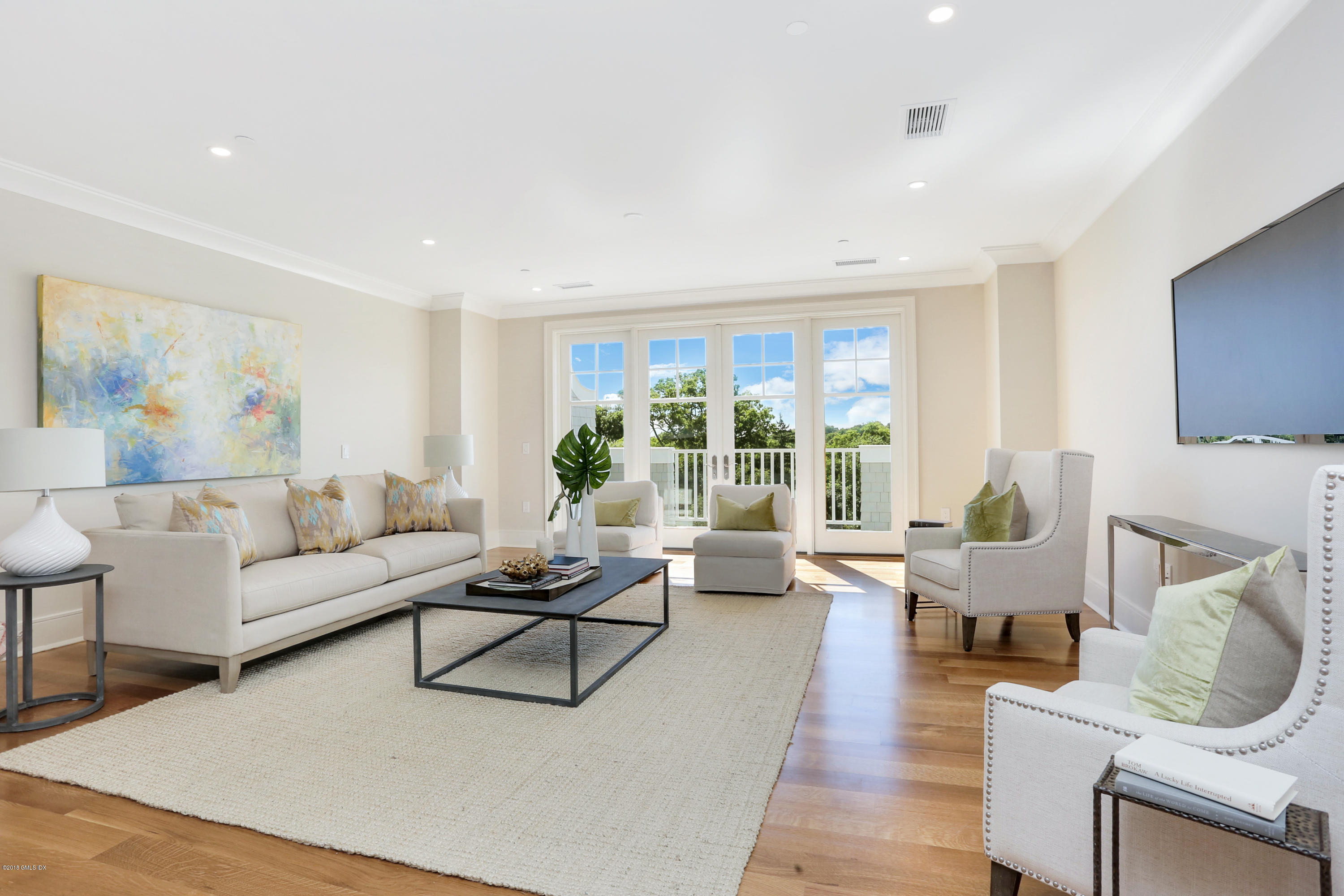 70 Sound View Drive, Unit 2 WEST Greenwich, CT 06830 - Photo 4 of 12 a living room with furniture and floor to ceiling window