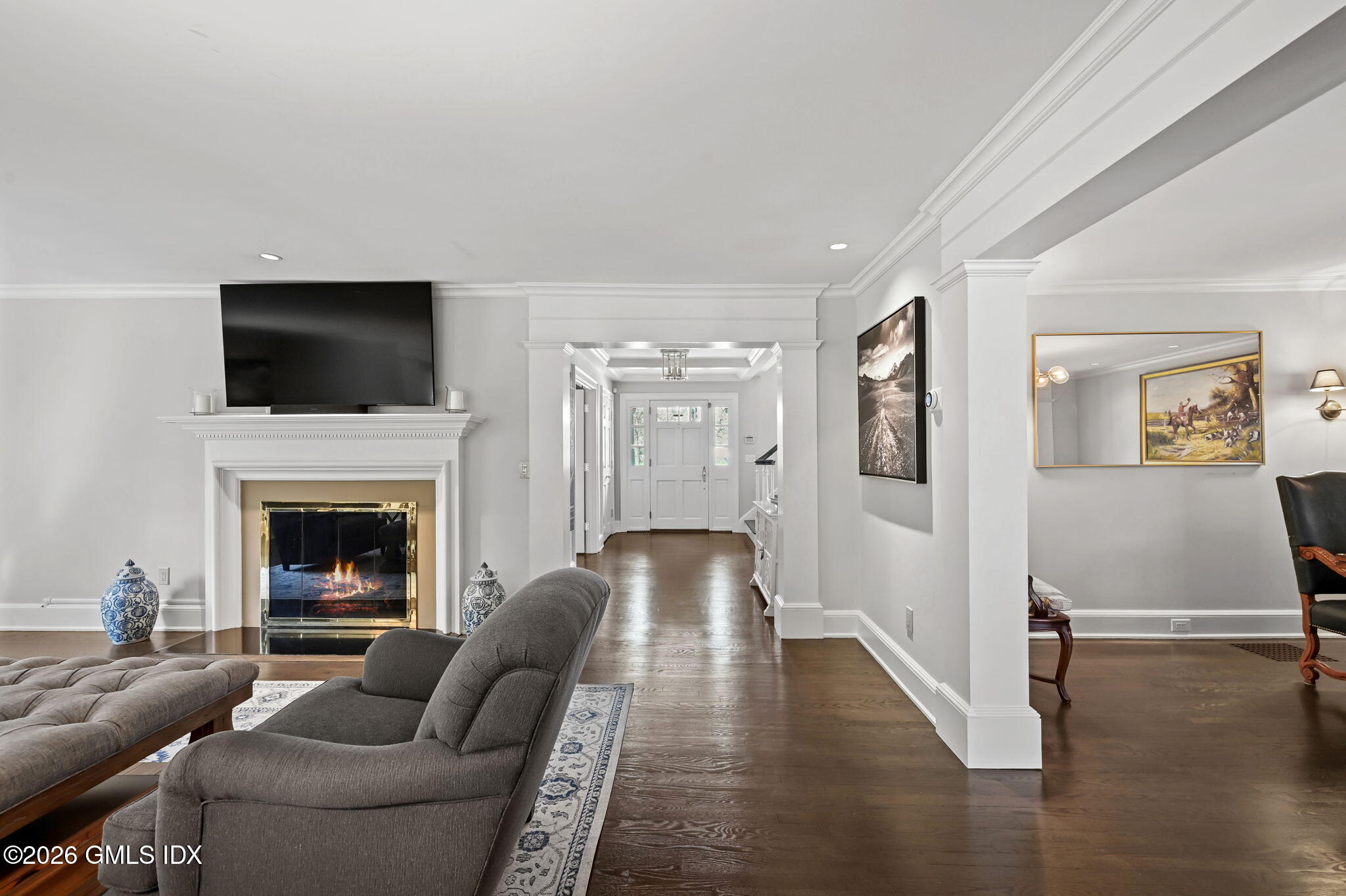 8 Haskell Lane Darien, CT 06820 - Photo 12 of 40 a living room with furniture a flat screen tv and a fireplace