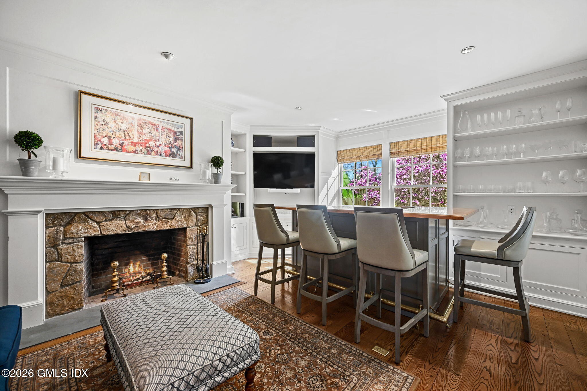 8 Haskell Lane Darien, CT 06820 - Photo 19 of 40 a living room with furniture a flat screen tv and a fireplace