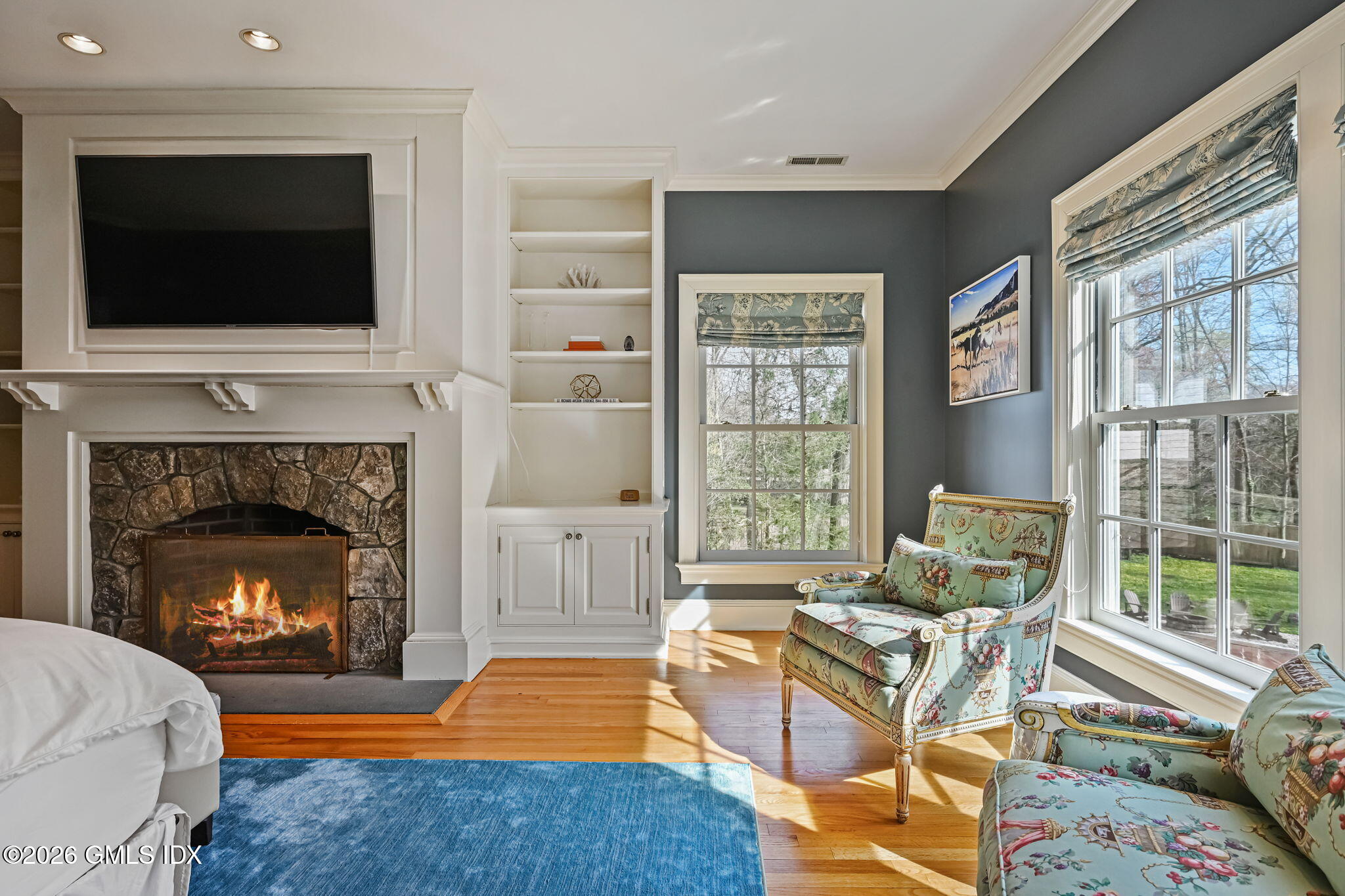 8 Haskell Lane Darien, CT 06820 - Photo 23 of 40 a living room with furniture a flat screen tv and a fireplace