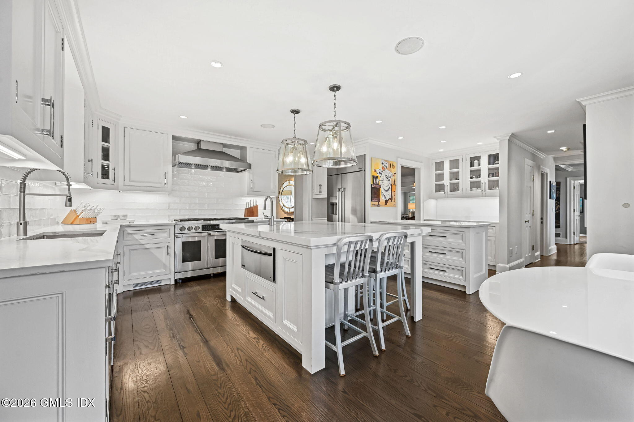 8 Haskell Lane Darien, CT 06820 - Photo 5 of 40 a kitchen with stainless steel appliances a white stove top oven a sink dishwasher and white cabinets with wooden floor