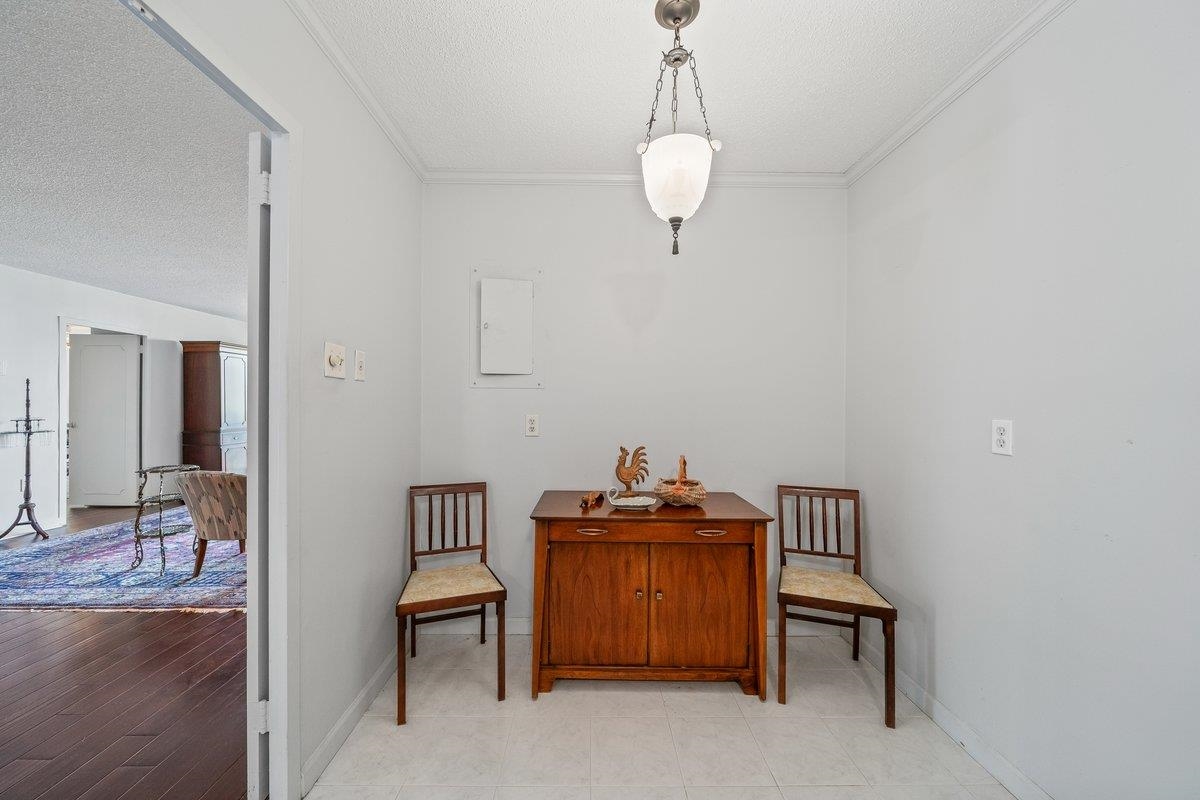 3080 Walnut Grove Road, Unit 507 Memphis, TN 38111 - Photo 15 of 27 Living area featuring a textured ceiling and crown molding