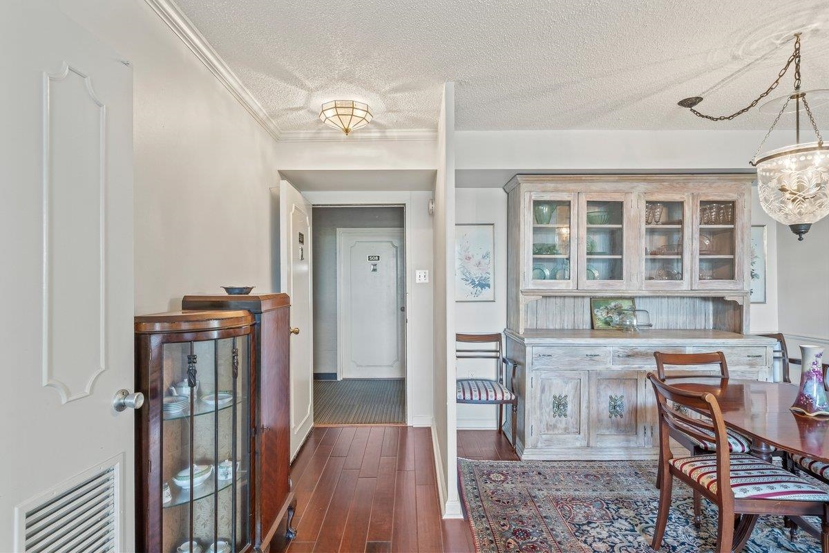 3080 Walnut Grove Road, Unit 507 Memphis, TN 38111 - Photo 5 of 27 Dining area featuring a textured ceiling, dark wood-style floors, and crown molding