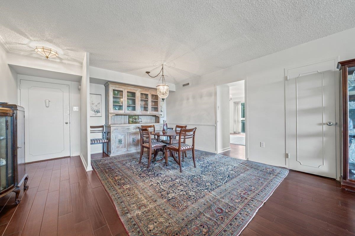 3080 Walnut Grove Road, Unit 507 Memphis, TN 38111 - Photo 6 of 27 Dining area with a textured ceiling and dark wood-style floors