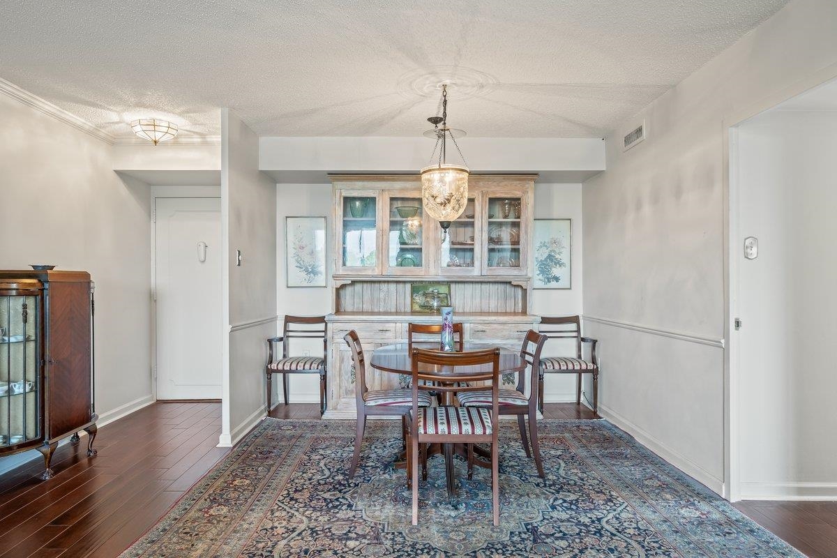 3080 Walnut Grove Road, Unit 507 Memphis, TN 38111 - Photo 7 of 27 Dining space with a textured ceiling and dark wood-style flooring