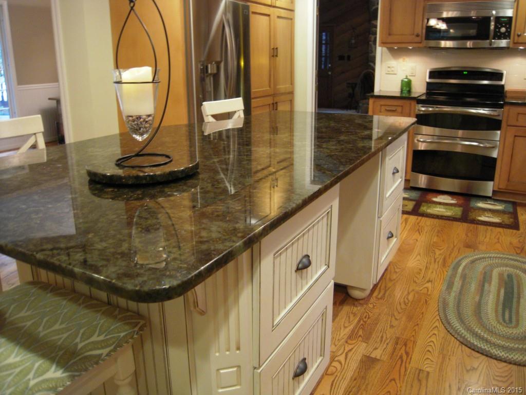 3226 Gray Moss Road Charlotte, NC 28270 - Photo 11 of 24 a kitchen with a stove and a chandelier