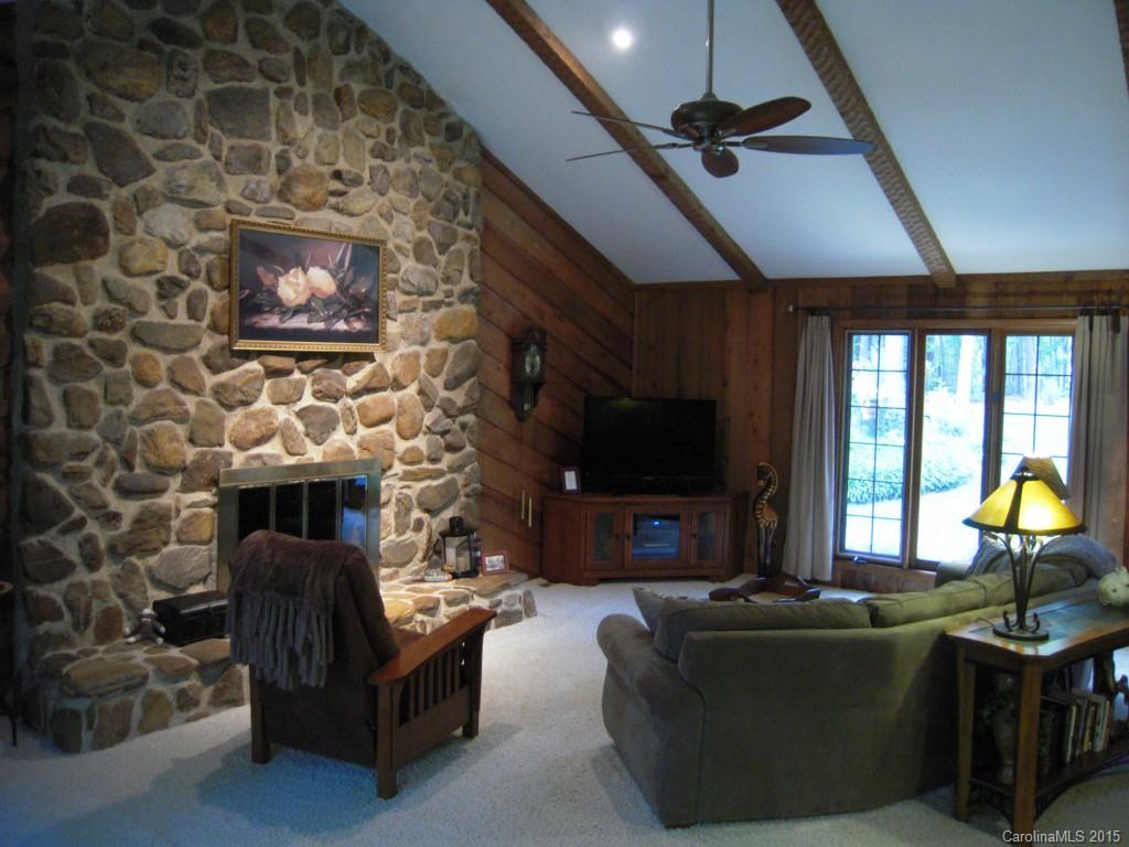 3226 Gray Moss Road Charlotte, NC 28270 - Photo 13 of 24 a living room with furniture a flat screen tv and a fireplace