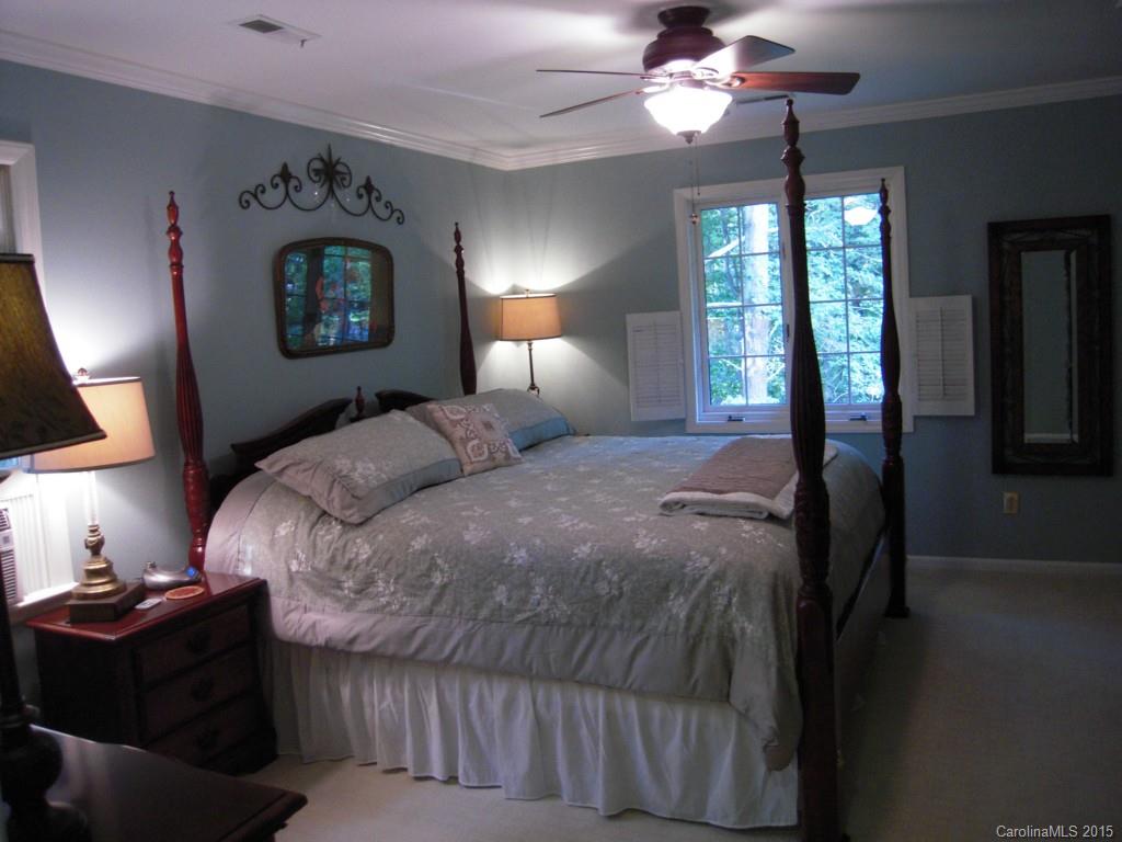 3226 Gray Moss Road Charlotte, NC 28270 - Photo 18 of 24 a bedroom with a bed and a lamp