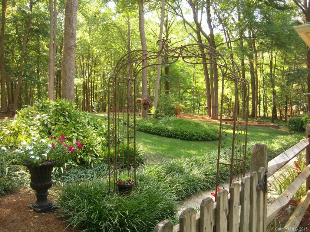 3226 Gray Moss Road Charlotte, NC 28270 - Photo 20 of 24 a view of a garden with a bench
