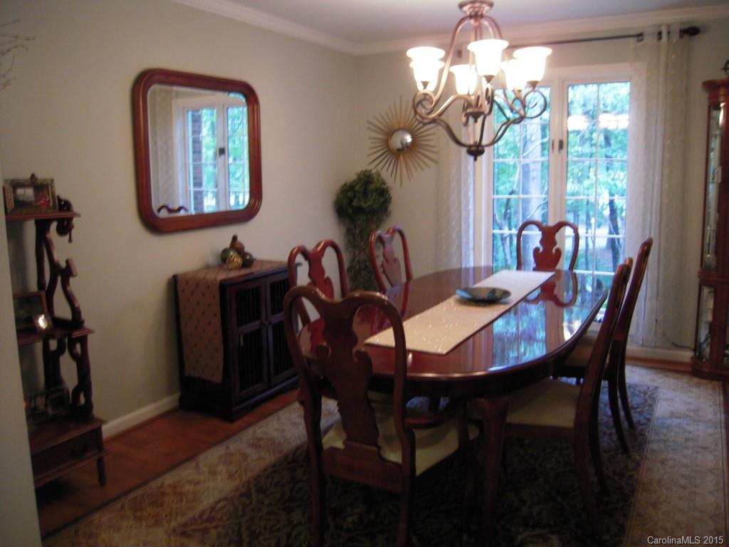 3226 Gray Moss Road Charlotte, NC 28270 - Photo 6 of 24 a view of a dining room with furniture and chandelier