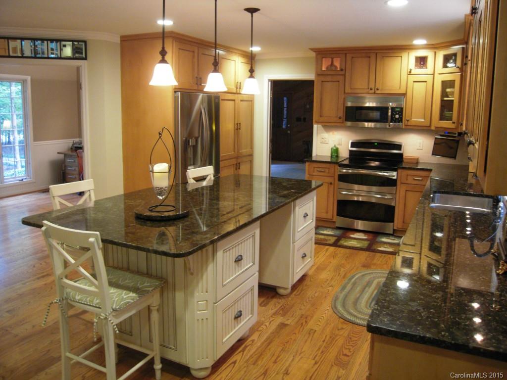 3226 Gray Moss Road Charlotte, NC 28270 - Photo 8 of 24 a kitchen with stainless steel appliances granite countertop a sink stove and refrigerator