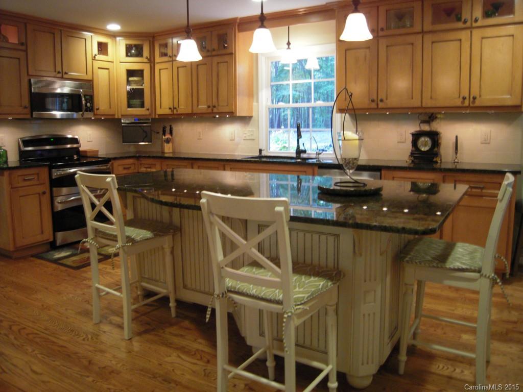 3226 Gray Moss Road Charlotte, NC 28270 - Photo 9 of 24 a kitchen with a sink a stove and cabinets