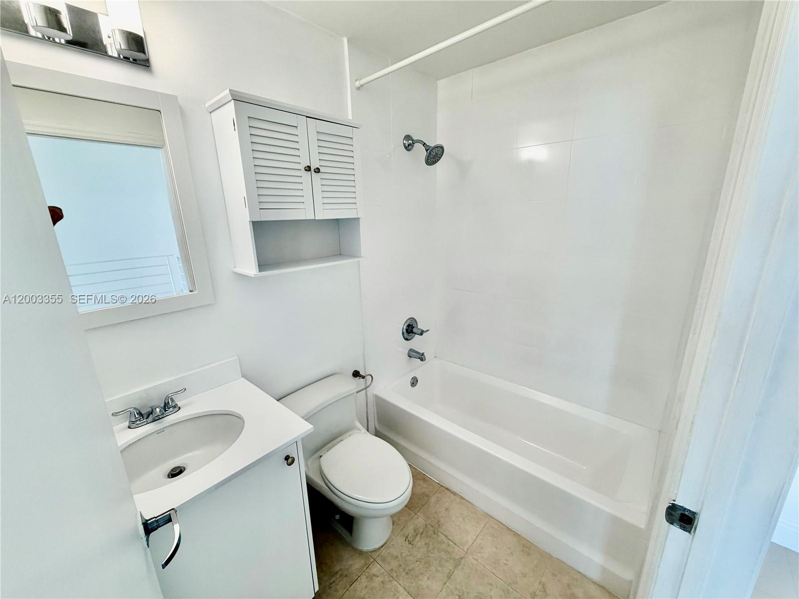 60 Southwest 13th Street, Unit 1605 Miami, FL 33130 - Photo 11 of 18 a bathroom with a white toilet sitting next to a bathroom sink and a bathtub