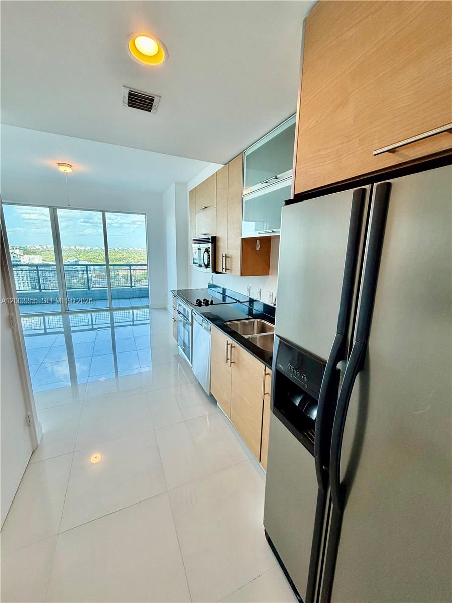 60 Southwest 13th Street, Unit 1605 Miami, FL 33130 - Photo 13 of 18 a kitchen with stainless steel appliances a refrigerator and a sink