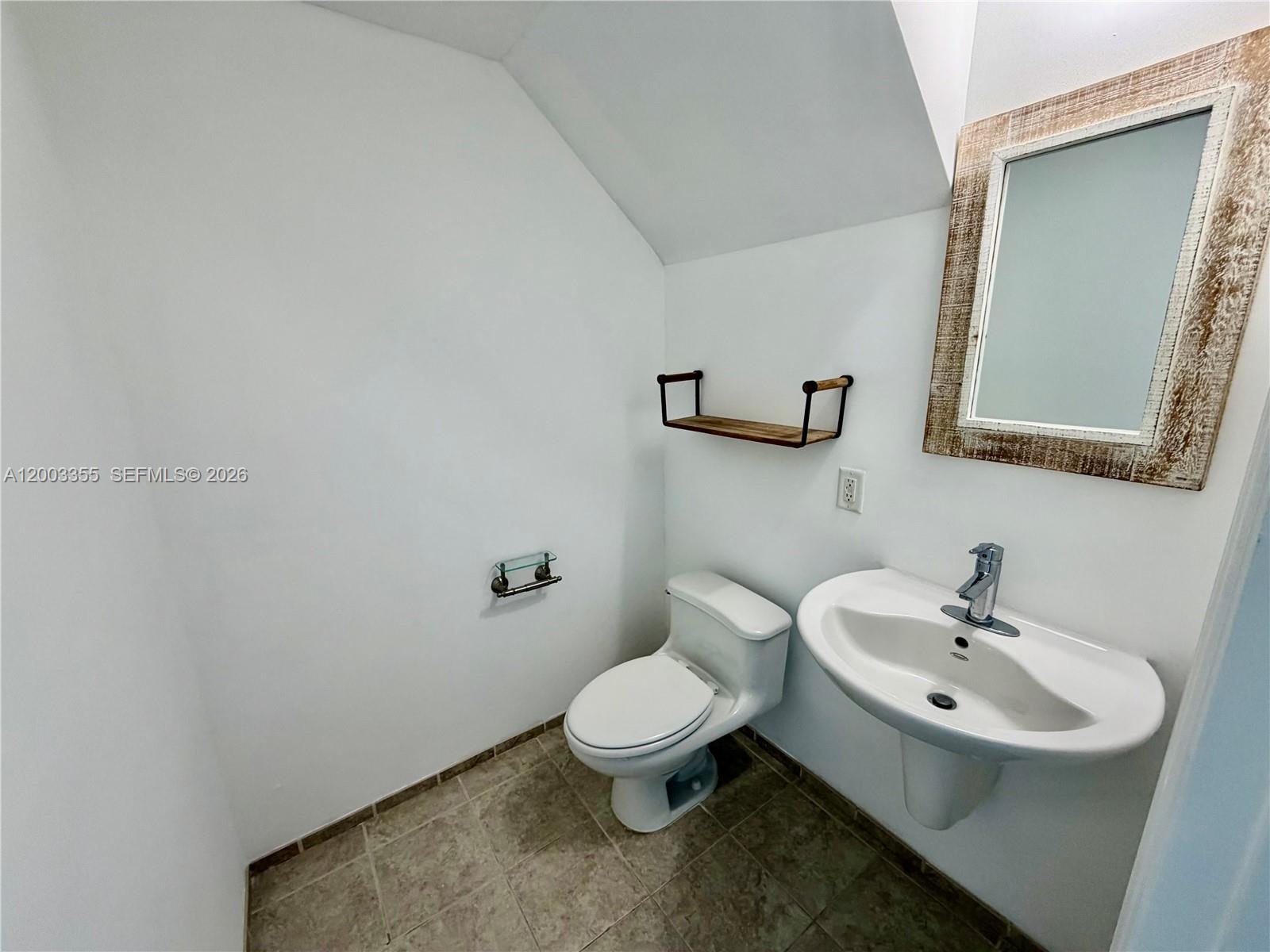 60 Southwest 13th Street, Unit 1605 Miami, FL 33130 - Photo 8 of 18 a white toilet sitting next to a bathroom sink