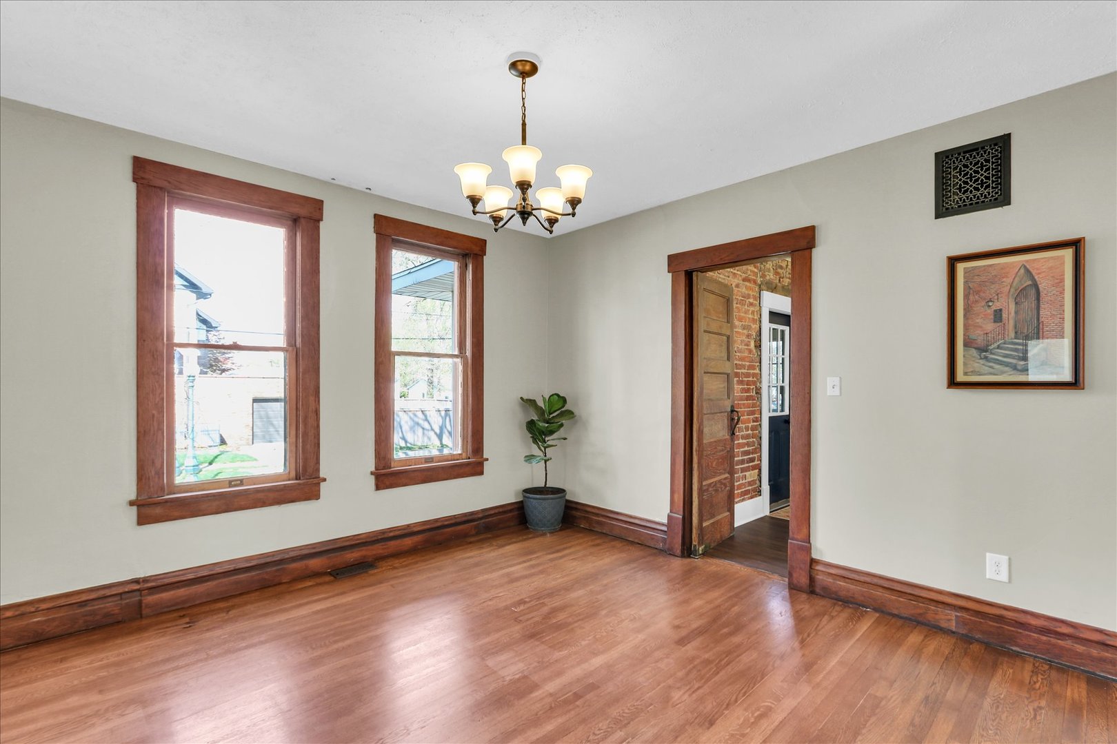 1120 West Church Street Champaign, IL 61821 - Photo 15 of 49 a view of an empty room with window and wooden floor