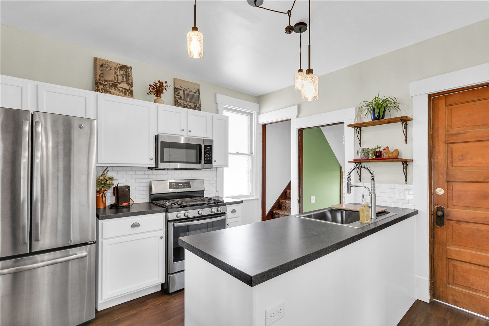 1120 West Church Street Champaign, IL 61821 - Photo 16 of 49 a kitchen with stainless steel appliances granite countertop a sink stove and refrigerator