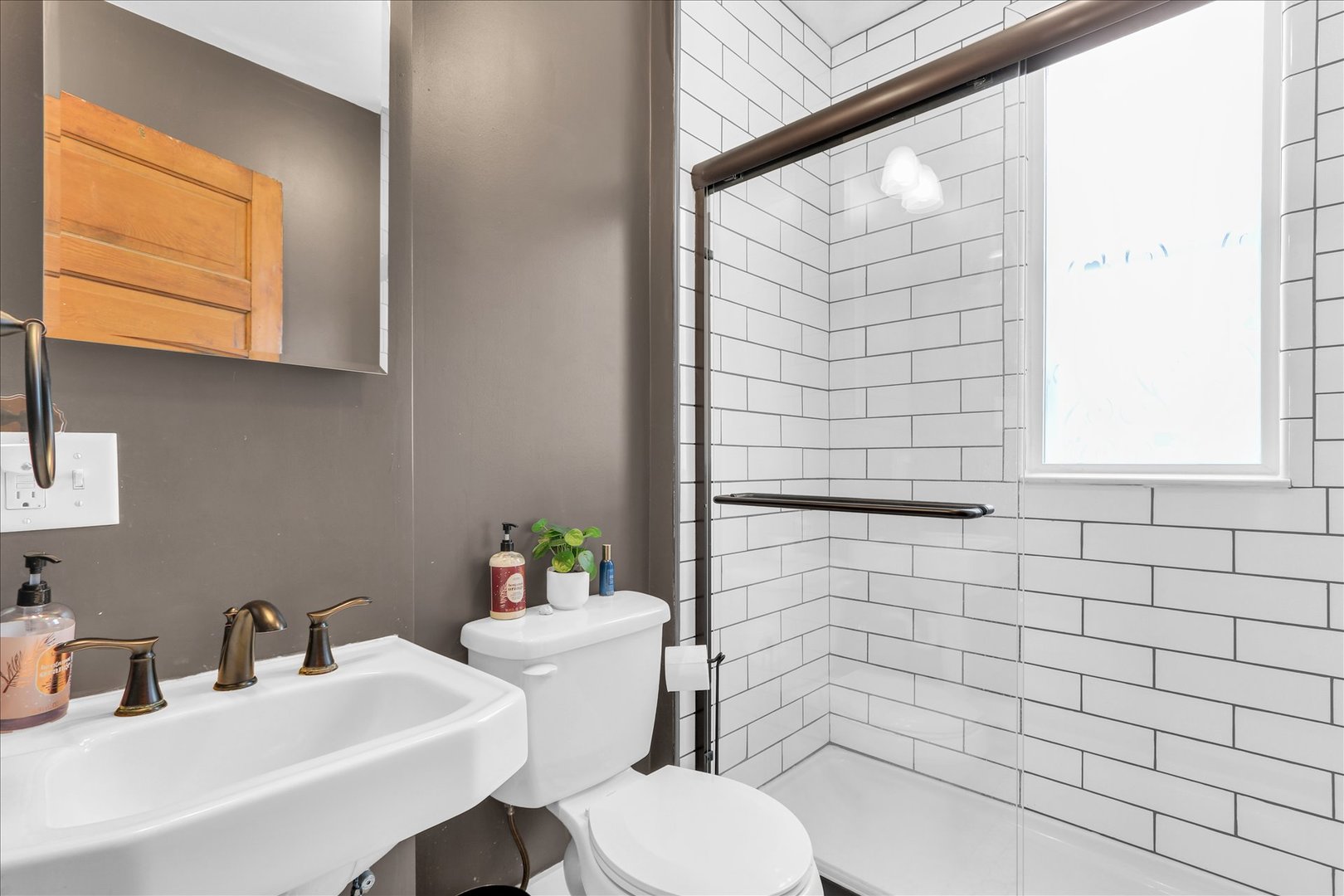 1120 West Church Street Champaign, IL 61821 - Photo 20 of 49 a bathroom with a sink mirror and toilet