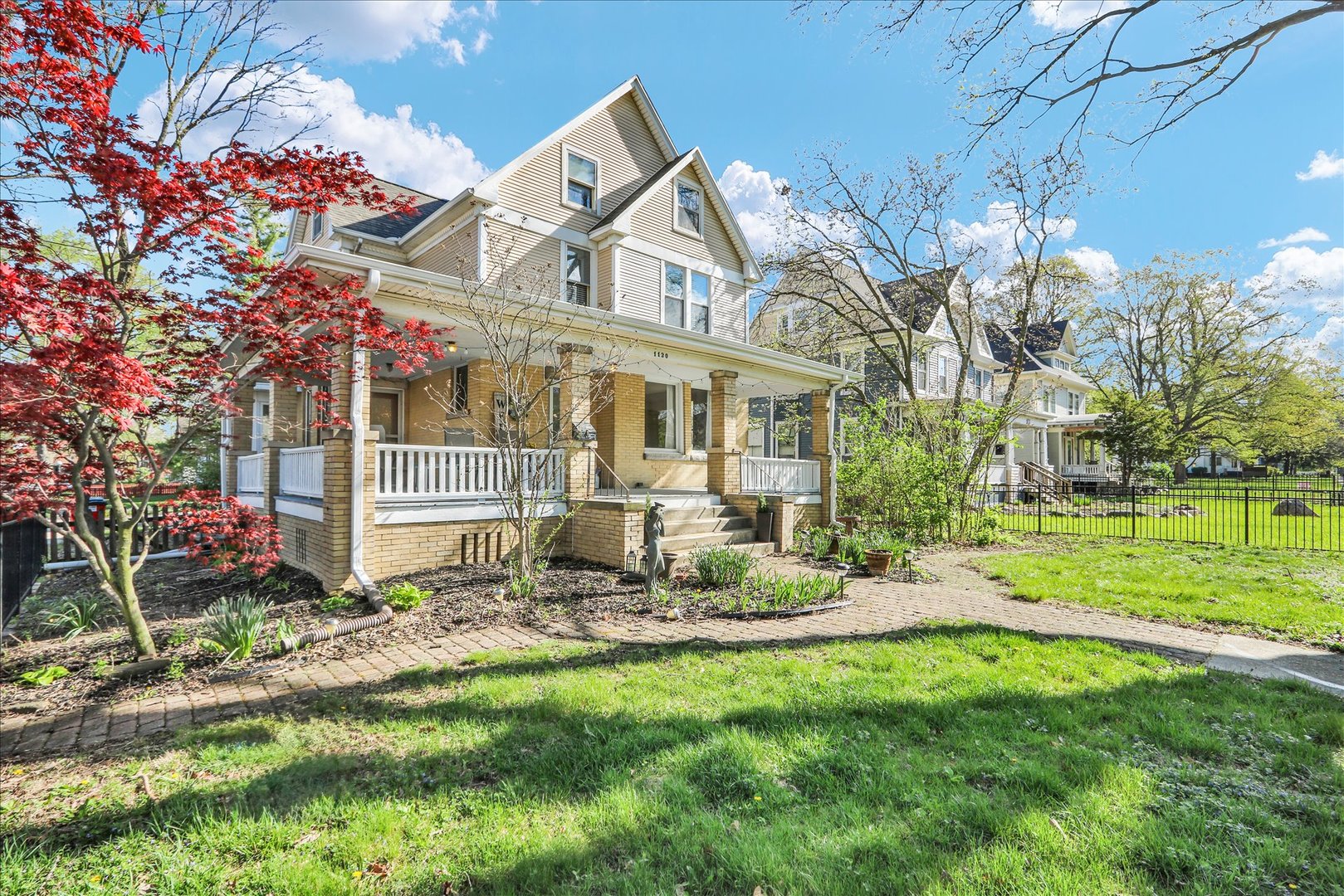 1120 West Church Street Champaign, IL 61821 - Photo 2 of 49 a view of a house with a yard and sitting area