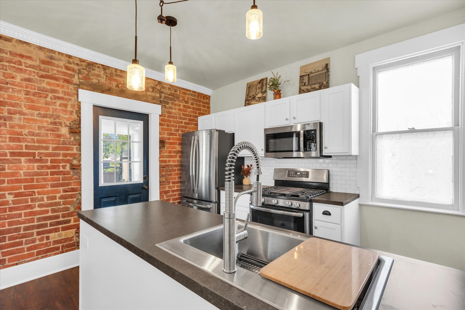 1120 West Church Street Champaign, IL 61821 - Photo 22 of 48 a kitchen with stainless steel appliances granite countertop a sink a stove and a refrigerator