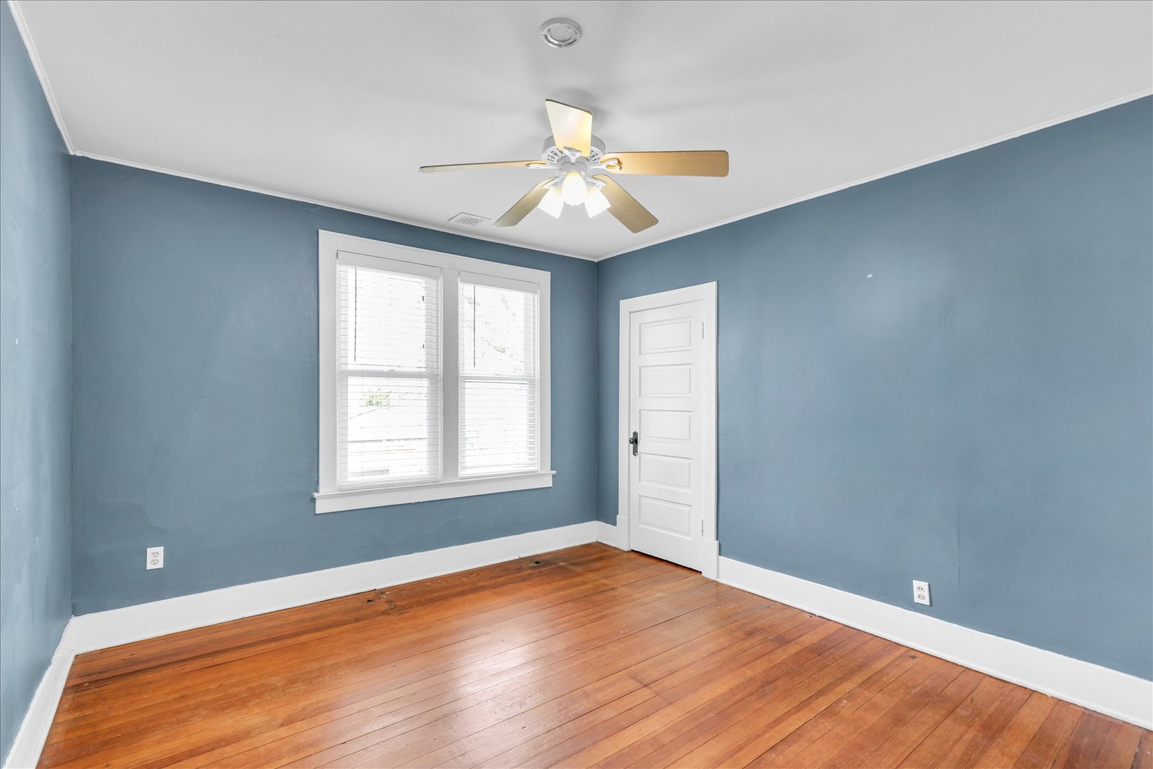 1120 West Church Street Champaign, IL 61821 - Photo 29 of 49 an empty room with wooden floor chandelier fan and windows