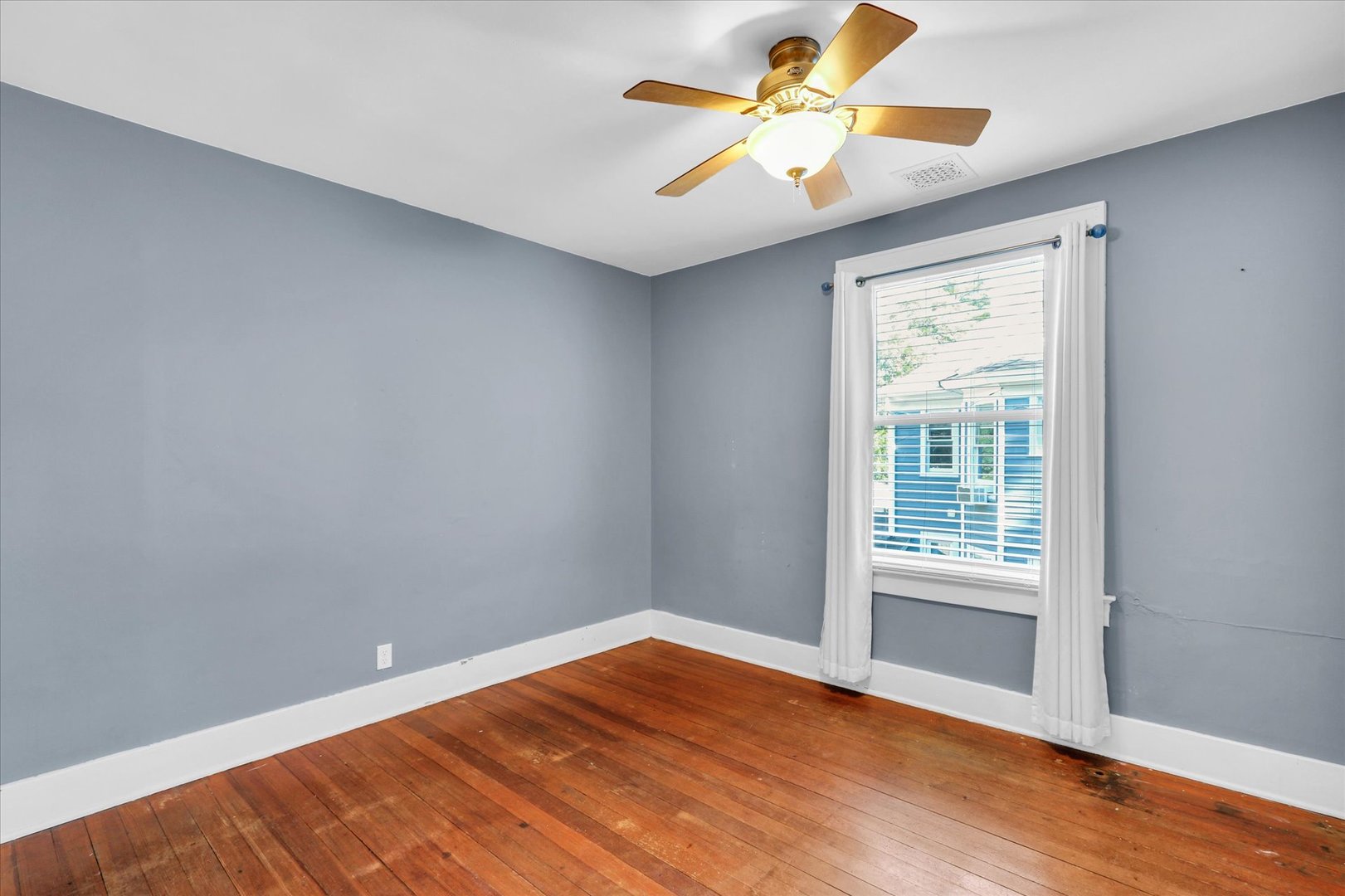 1120 West Church Street Champaign, IL 61821 - Photo 31 of 48 an empty room with wooden floor and windows