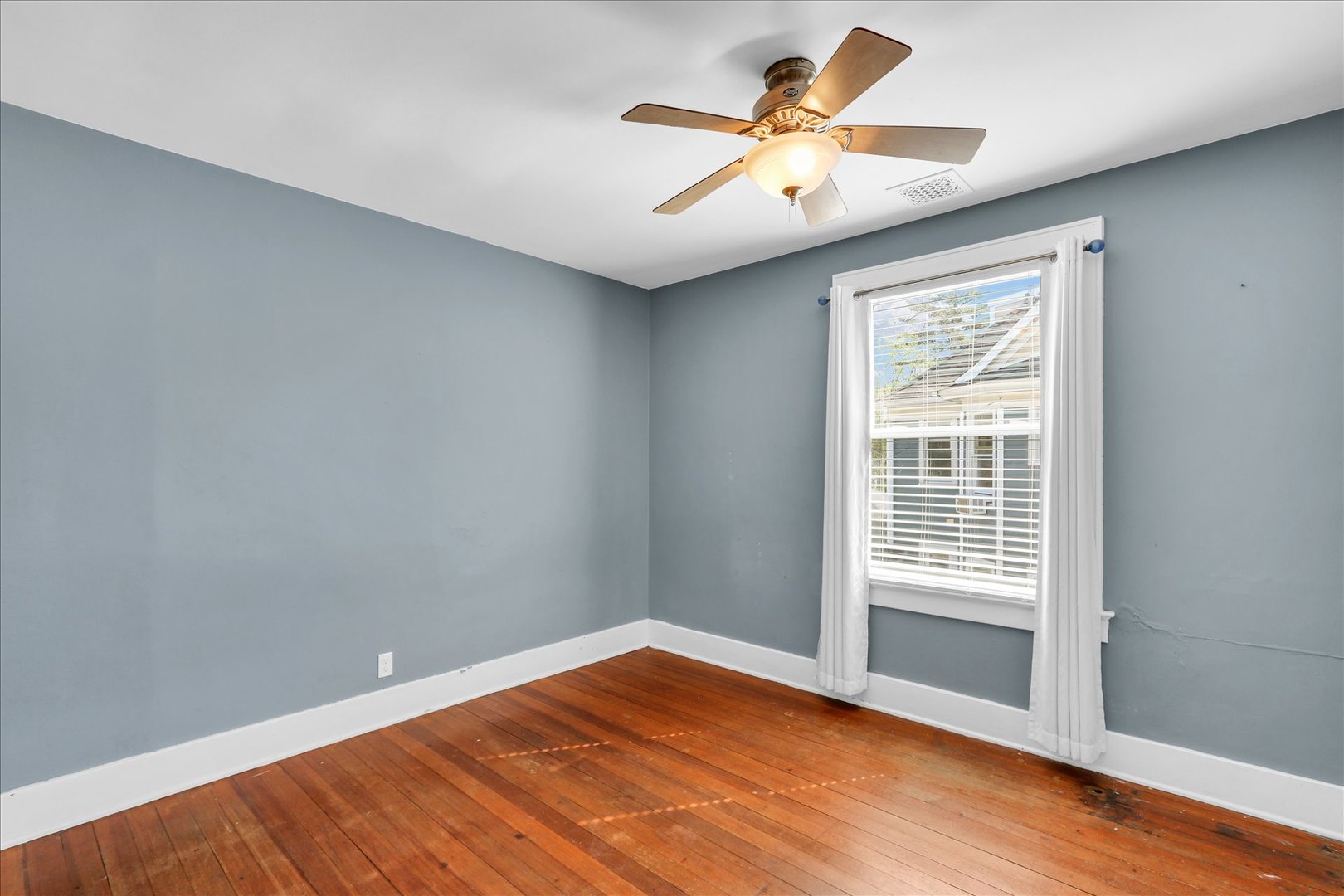 1120 West Church Street Champaign, IL 61821 - Photo 31 of 49 an empty room with wooden floor and windows