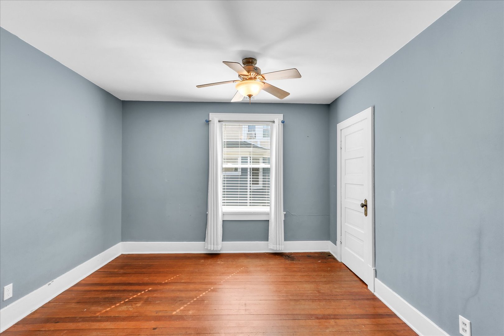 1120 West Church Street Champaign, IL 61821 - Photo 32 of 49 a view of empty room with wooden floor and fan