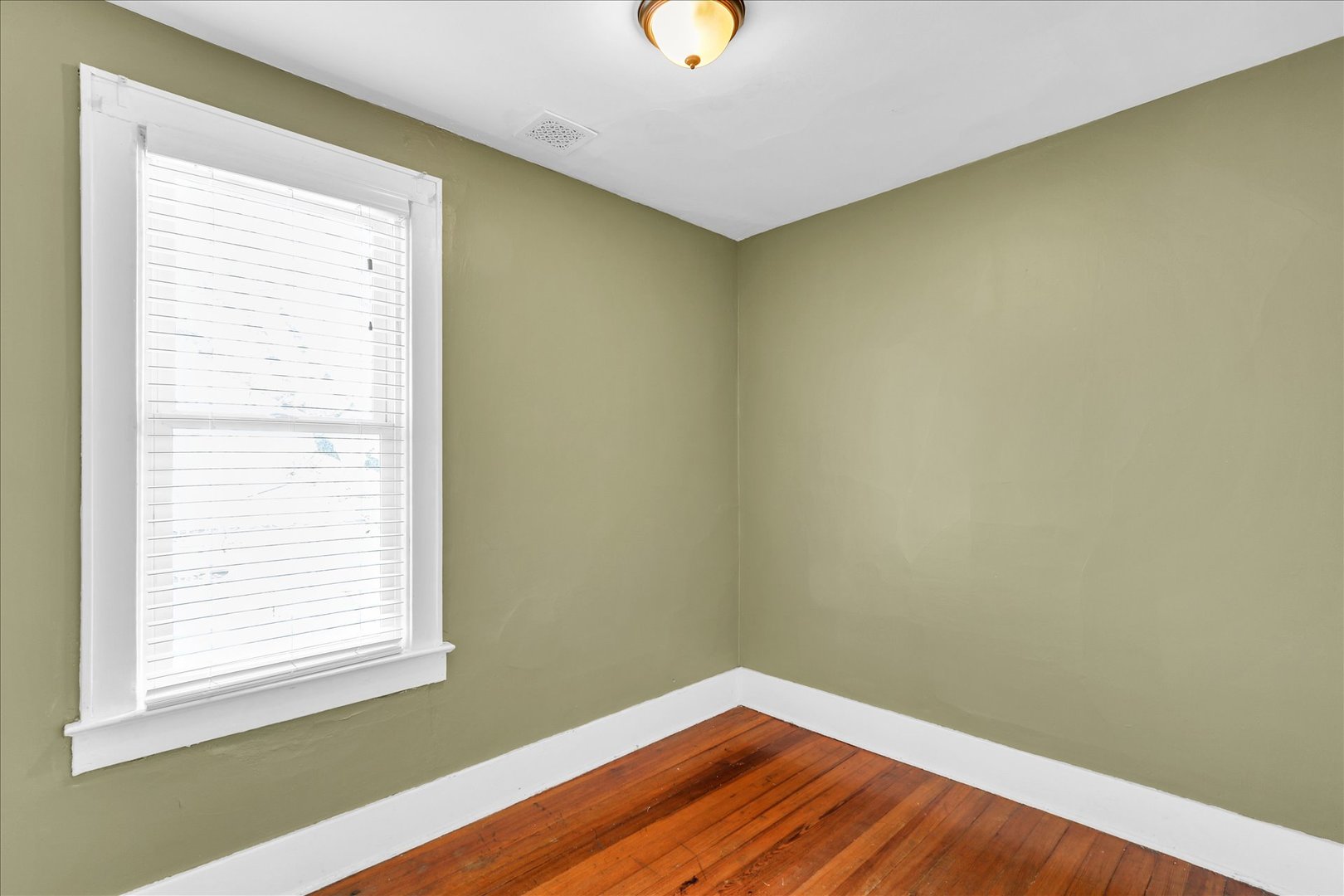 1120 West Church Street Champaign, IL 61821 - Photo 34 of 49 a view of a room with wooden floor and a window