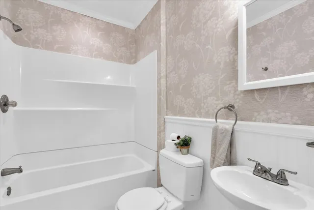 a bathroom with a sink a toilet and bathtub