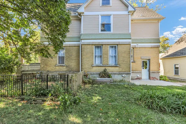 a front view of a house with outdoor seating