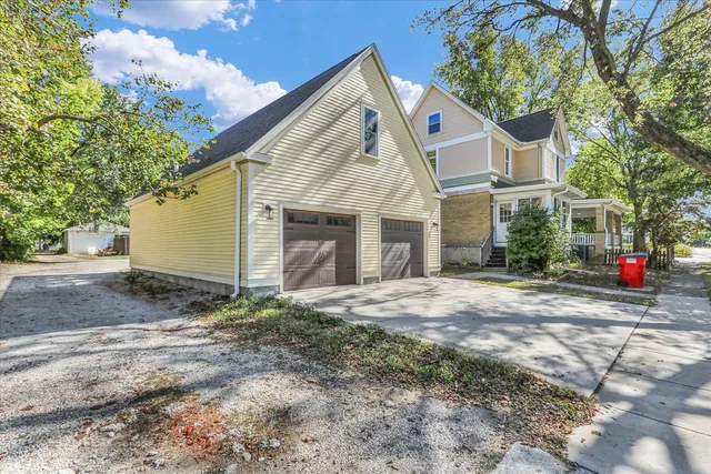 a view of a house with a yard and garage